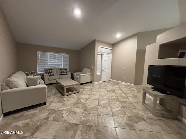 living room with baseboards and lofted ceiling