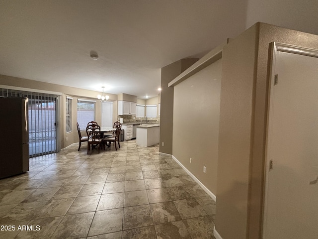 dining area with baseboards and a chandelier