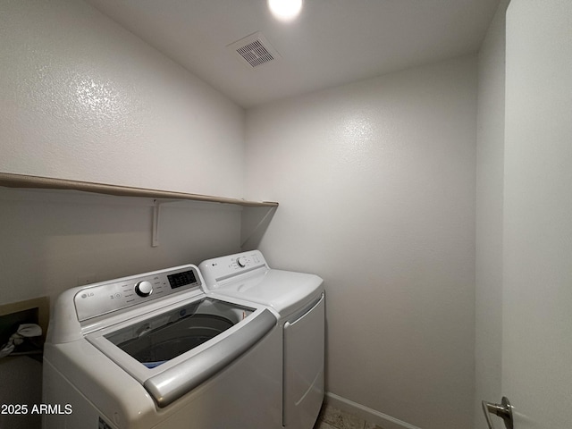 laundry room with visible vents, laundry area, and separate washer and dryer