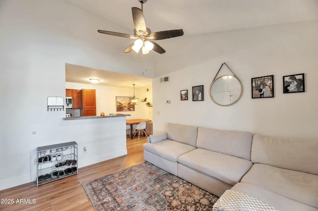 623 W Guadalupe Rd Unit 213, Mesa, AZ 85210 - living area with baseboards, ceiling fan with notable chandelier, visible vents, and light wood-style flooring