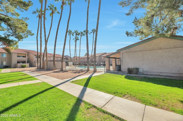 623 W Guadalupe Rd Unit 213, Mesa, AZ 85210 - view of property's community with fence, a swimming pool, a yard, and a residential view