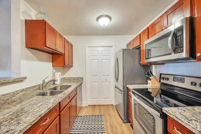 623 W Guadalupe Rd Unit 213, Mesa, AZ 85210 - kitchen with appliances with stainless steel finishes, light stone countertops, a sink, and light wood finished floors
