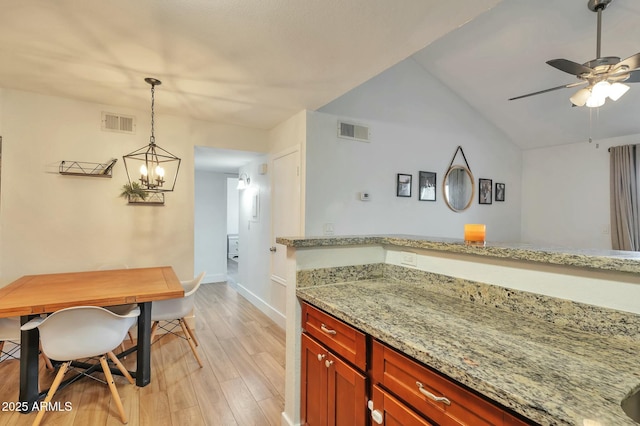 623 W Guadalupe Rd Unit 213, Mesa, AZ 85210 - kitchen with ceiling fan with notable chandelier, baseboards, visible vents, and light wood-style floors