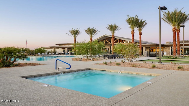 view of pool at dusk