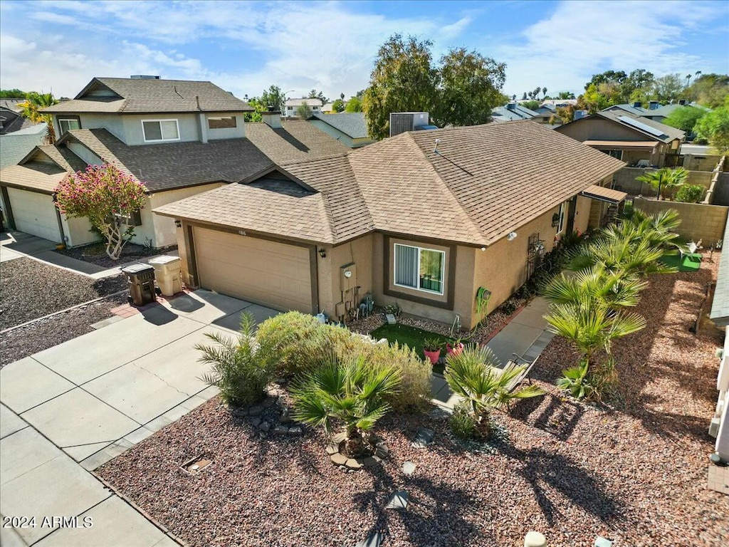 view of front of property with central AC unit and a garage