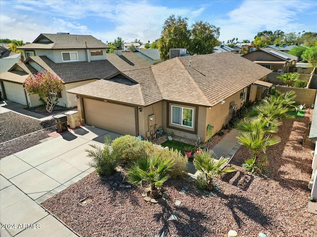 view of front of property with central AC unit and a garage