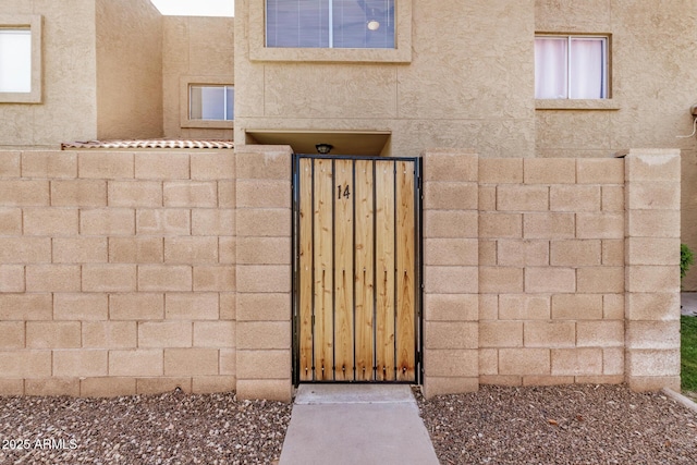 222 W Brown Rd Unit 14, Mesa, AZ 85201 - view of exterior entry featuring a gate and stucco siding