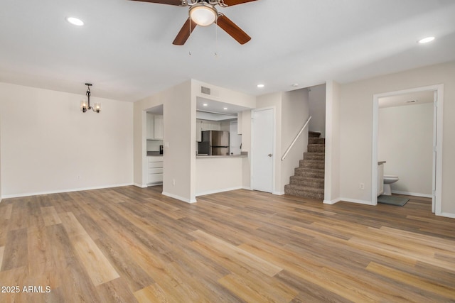 222 W Brown Rd Unit 14, Mesa, AZ 85201 - unfurnished living room with ceiling fan, stairs, a chandelier, light wood-type flooring, and recessed lighting