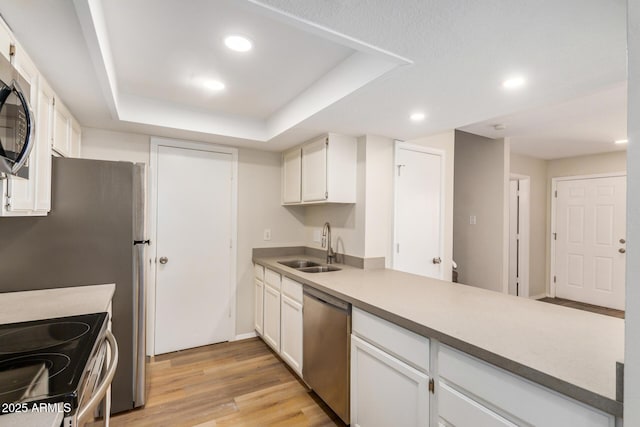 222 W Brown Rd Unit 14, Mesa, AZ 85201 - kitchen with appliances with stainless steel finishes, a peninsula, white cabinets, light wood-style flooring, and recessed lighting