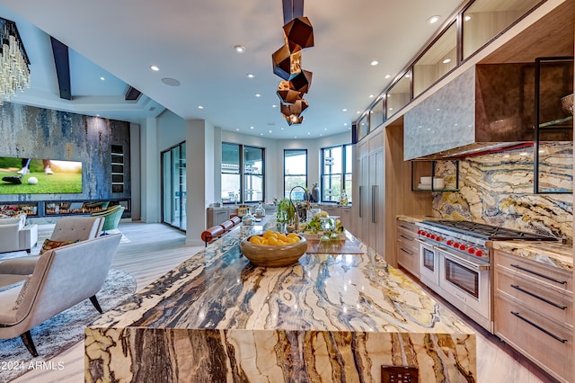 kitchen featuring double oven range and light brown cabinets