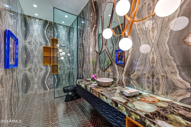 bathroom with vanity and tile walls