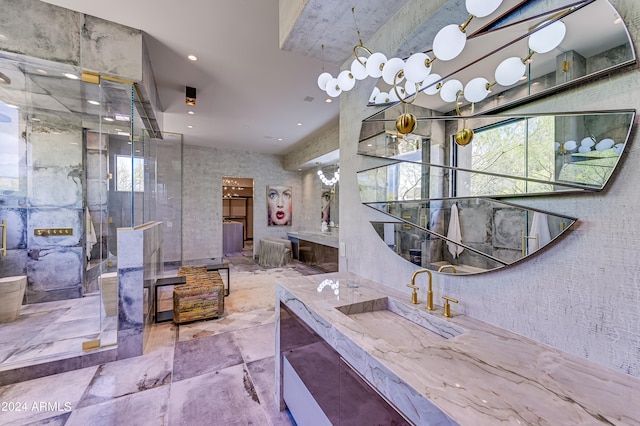 bathroom with a shower with door and vanity