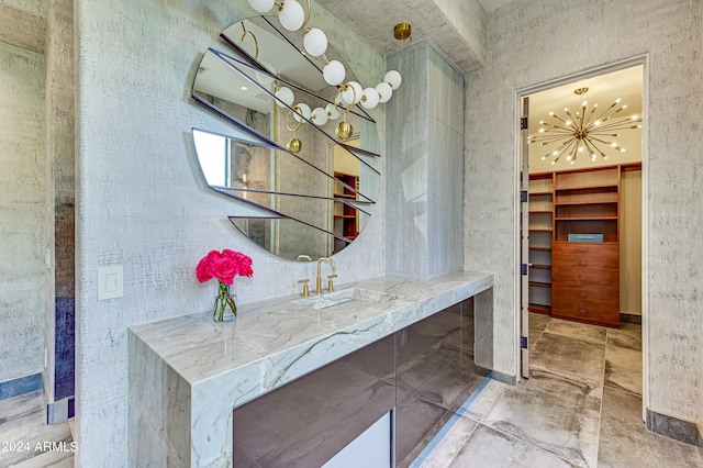 bathroom with a chandelier and sink