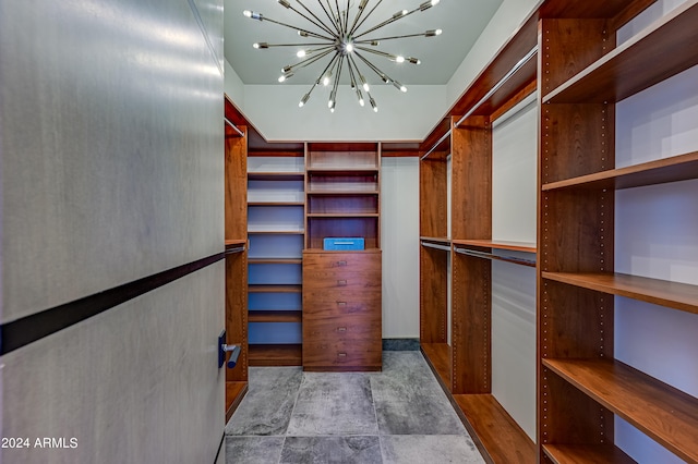 spacious closet featuring an inviting chandelier