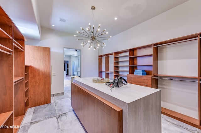 walk in closet with an inviting chandelier