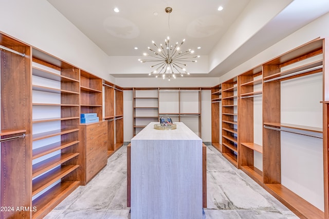 spacious closet featuring an inviting chandelier