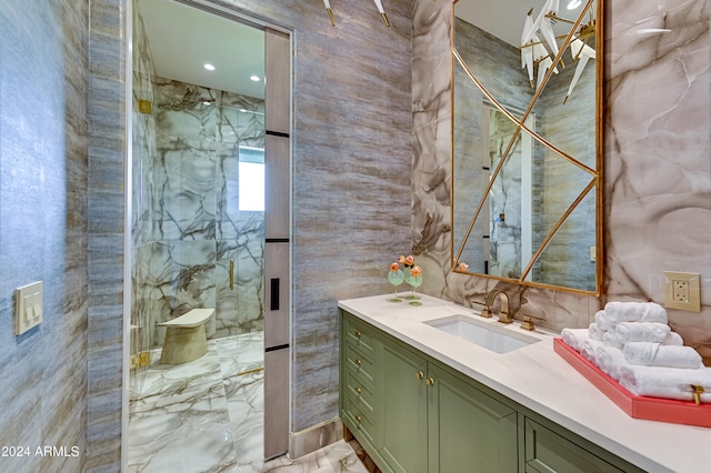 bathroom with a shower with door and vanity