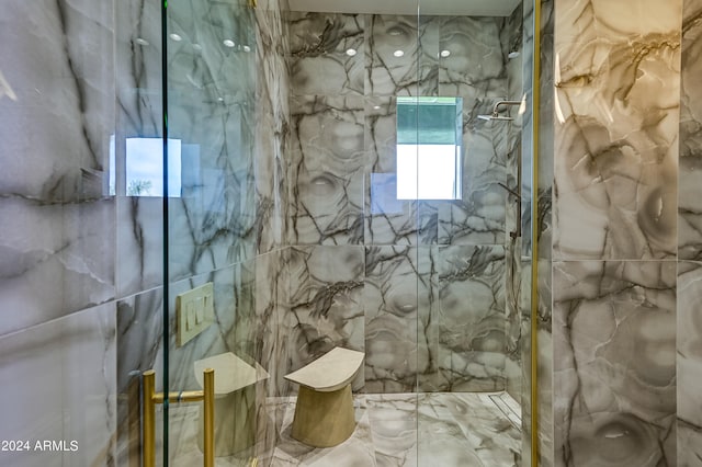 bathroom with tile walls and tiled shower