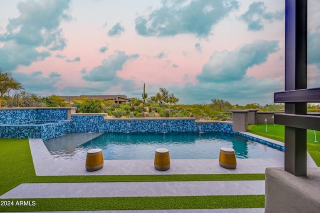 view of pool at dusk