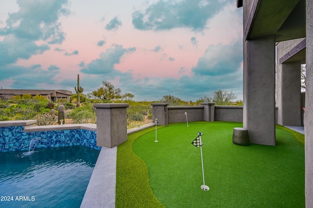 view of pool at dusk