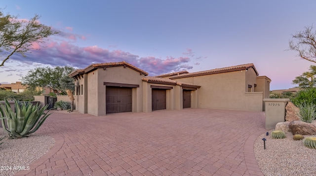 mediterranean / spanish-style house with a garage