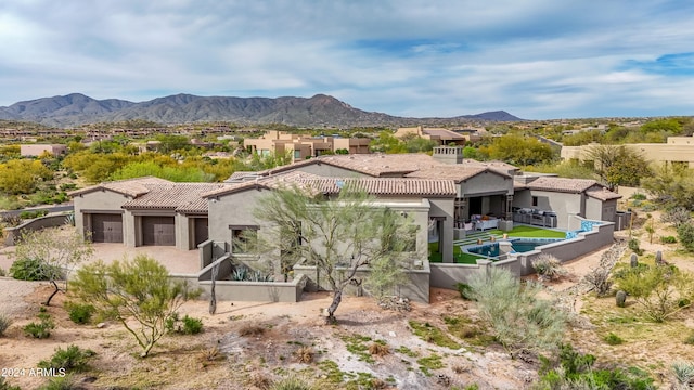 back of property with a mountain view