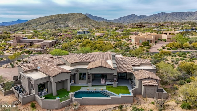 birds eye view of property with a mountain view