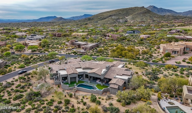 birds eye view of property with a mountain view