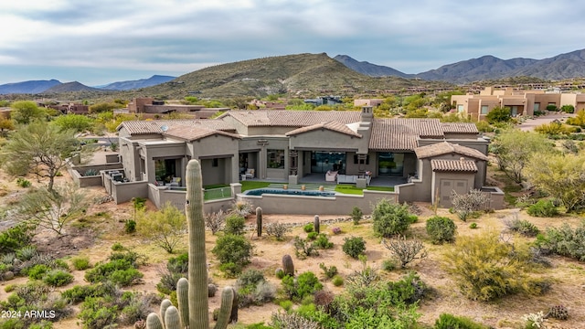 back of house featuring a patio and a mountain view