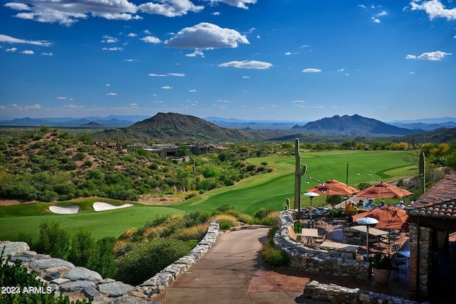 surrounding community with a patio, a lawn, and a mountain view