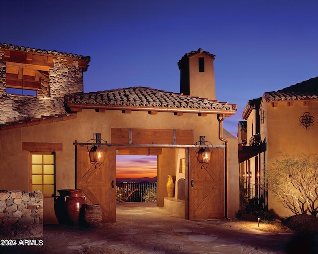 view of back house at dusk