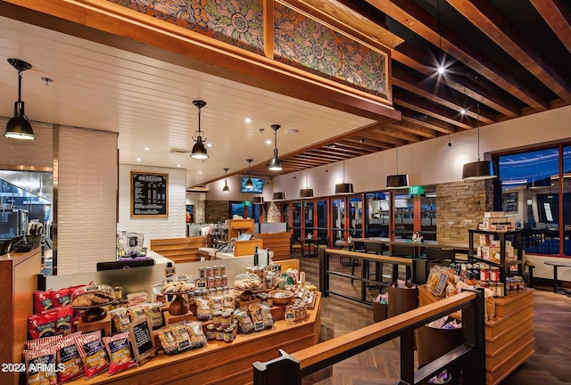 interior space with parquet flooring and beam ceiling