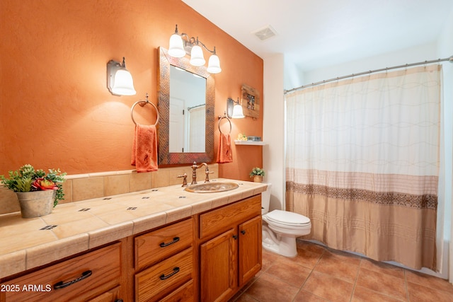 bathroom with a shower with curtain, visible vents, tile patterned floors, vanity, and toilet
