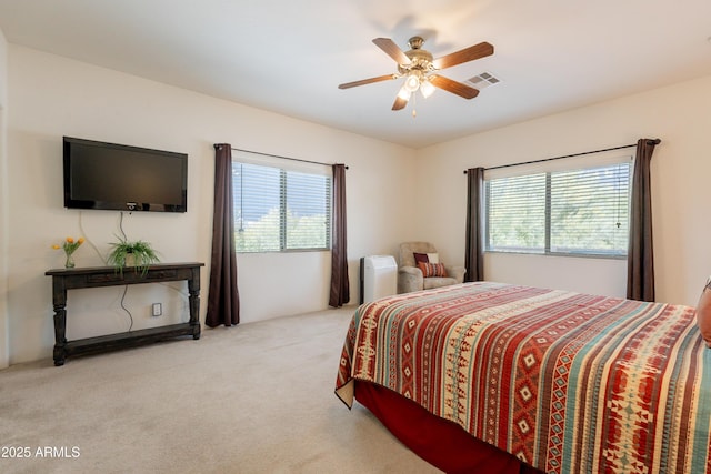 bedroom with ceiling fan, visible vents, and carpet