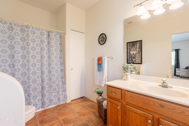 full bath featuring vanity, visible vents, and toilet