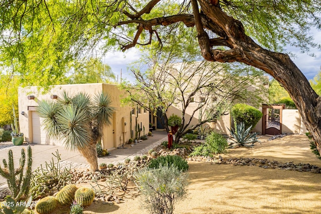 southwest-style home with concrete driveway, an attached garage, and stucco siding
