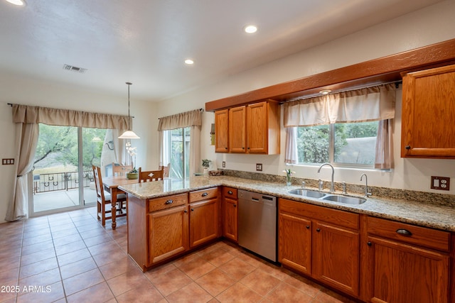 kitchen with brown cabinetry, visible vents, dishwasher, a sink, and a peninsula