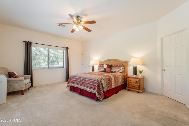 bedroom with carpet floors, a ceiling fan, and visible vents