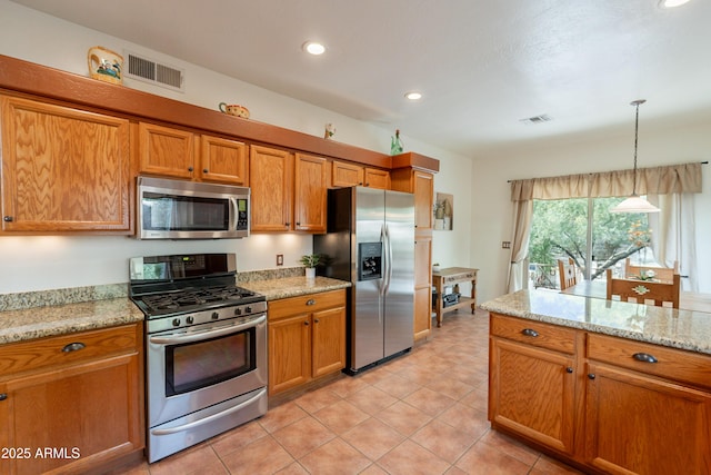 kitchen featuring visible vents, brown cabinets, and stainless steel appliances