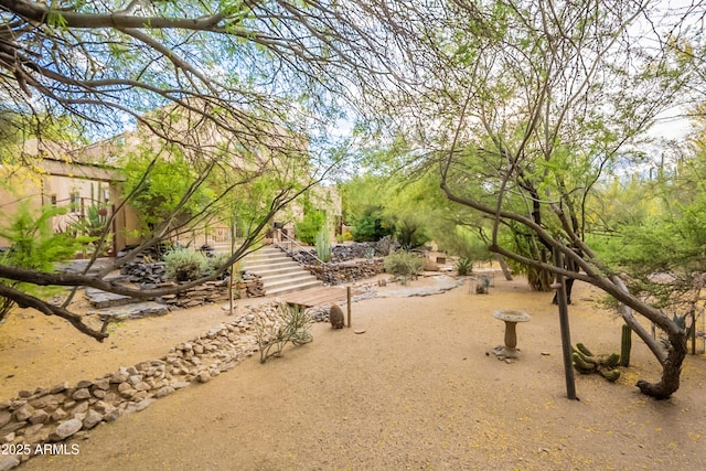 view of home's community featuring stairway