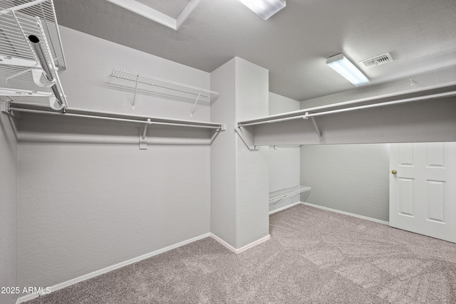 walk in closet with carpet flooring and visible vents