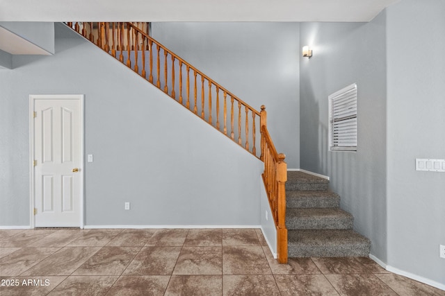 stairway with tile patterned flooring and baseboards