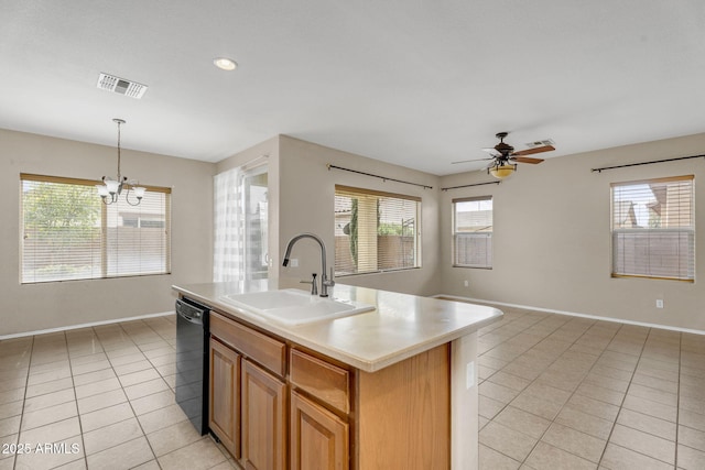 kitchen with visible vents, a sink, black dishwasher, light tile patterned flooring, and light countertops