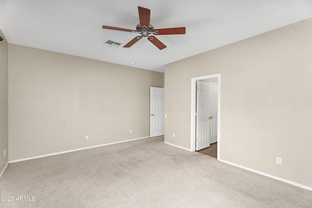 unfurnished bedroom featuring baseboards, carpet floors, visible vents, and ceiling fan