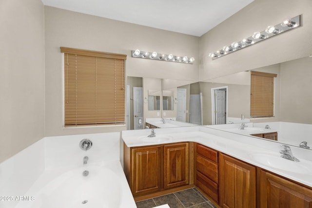 bathroom featuring a sink, a garden tub, and double vanity