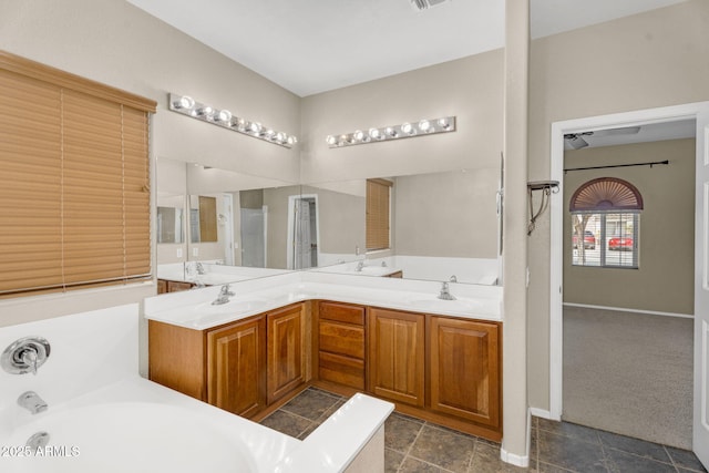 full bath with double vanity, a bath, visible vents, and a sink