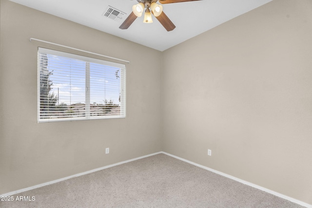 unfurnished room with visible vents, carpet flooring, a ceiling fan, and baseboards