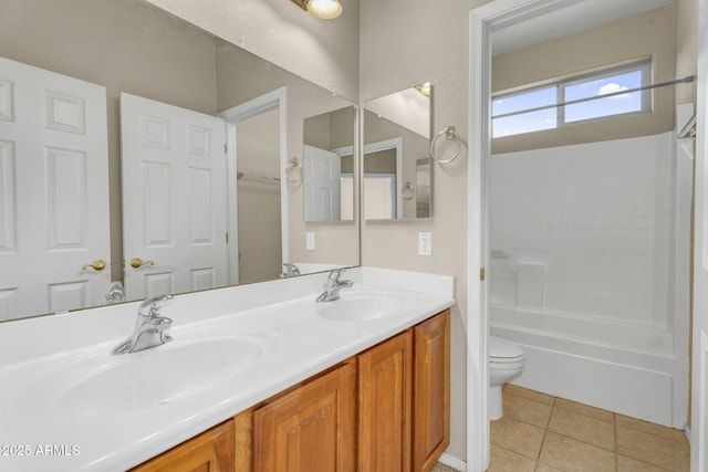 full bath with tile patterned floors, toilet, double vanity, and a sink