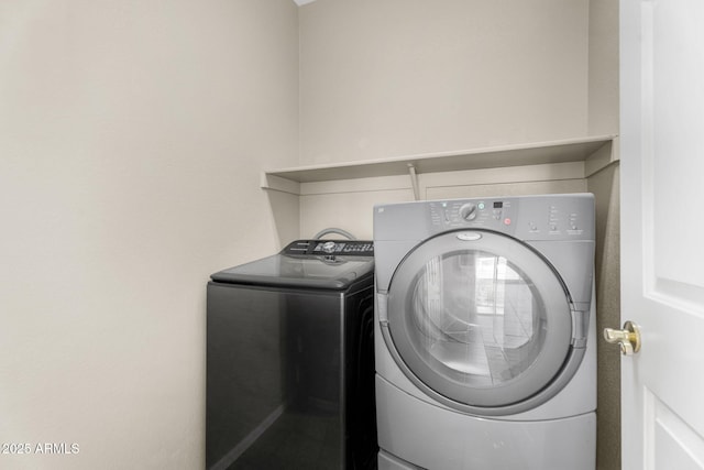 clothes washing area featuring washer and dryer and laundry area