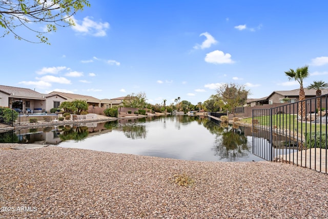 property view of water featuring a residential view and fence